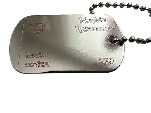 Allergy/Medical alert Metal dog tag with engraved text on a metal surface 
